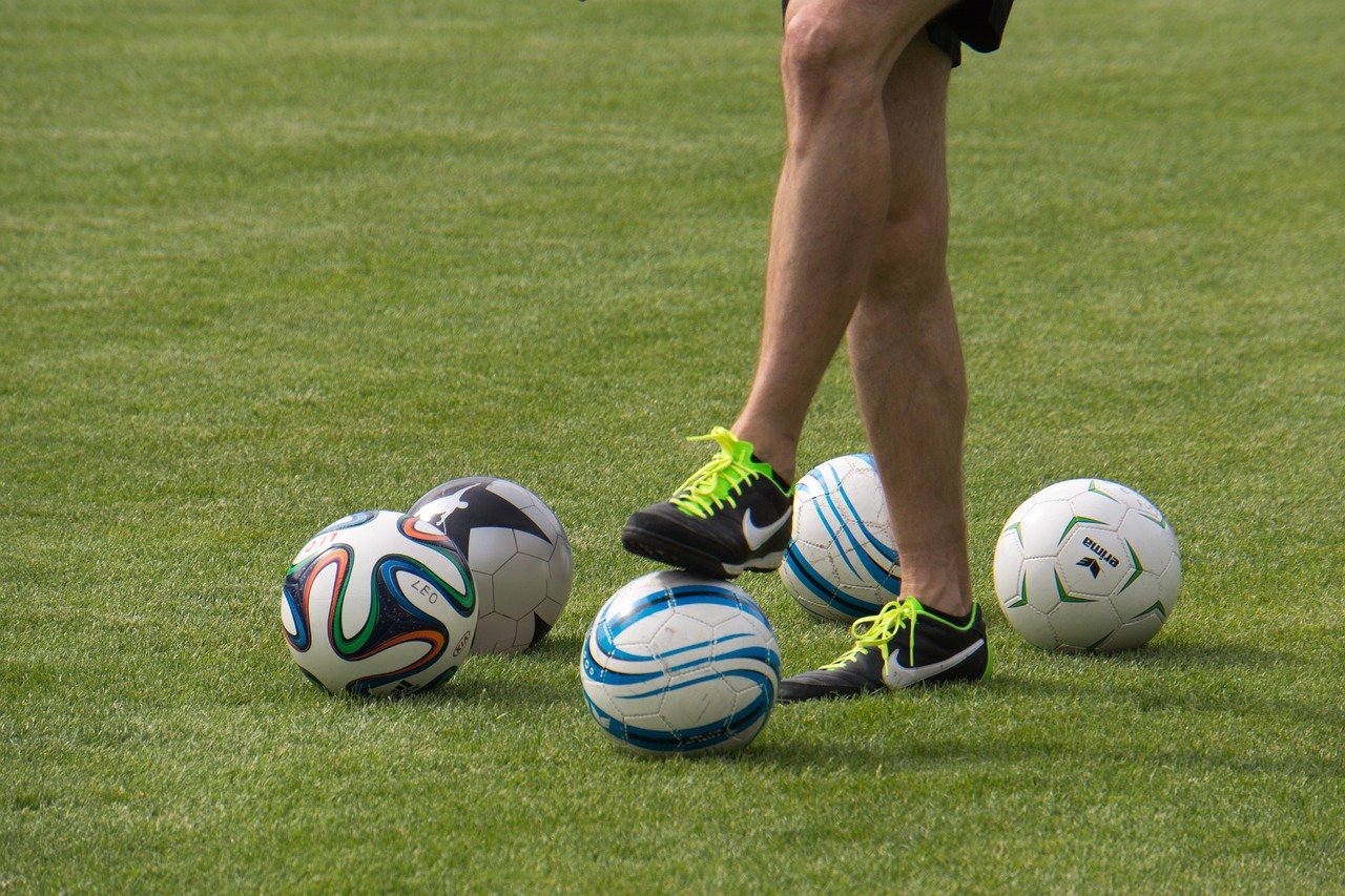 soccer balls and player trainer training kick a ball